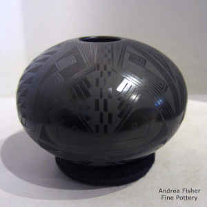 Bird element and geometric design on a black on glossy black jar