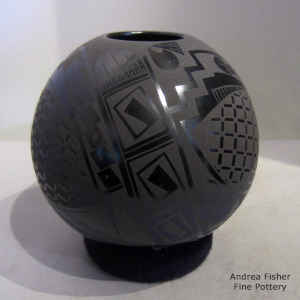 Black on black jar with a geometric design
