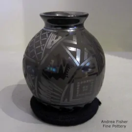 Geometric design in matte black on a polished black jar with a flared rim
