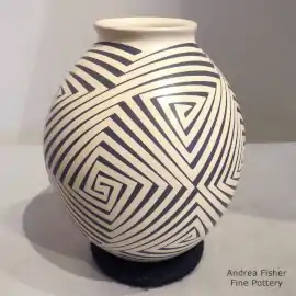 A geometric design in black on a beige jar with a flared rim