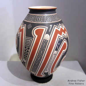 Lightly carved, sgraffito and painted geometric design on a polychrome jar