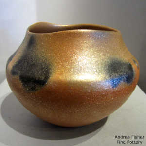 Fire clouds and an organic opening on a golden micaceous jar