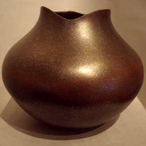 Organic opening on a black micaceous jar