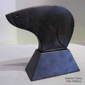 A sgraffito heart line on a micaceous black bear figure