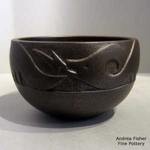 Lightly carved avanyu design on a black micaceous bowl