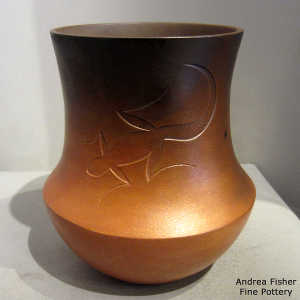 Fire clouds on a golden micaceous jar with a sgraffito lizard design
