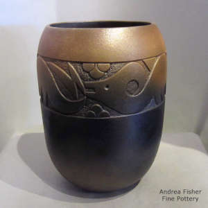 A sgraffito avanytu design with fire clouds on a golden micaceous jar