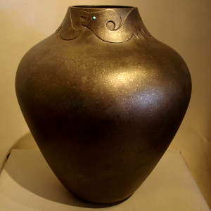 Fire clouds and a sgraffito avanyu design on a black micaceous jar