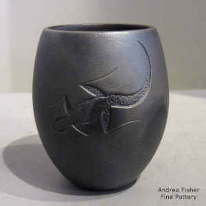 A sgraffito lizard design on a micaceous black jar