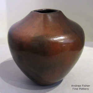 A brown vase with a square opening and fire clouds