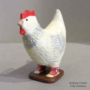 White chicken wearing red sneakers