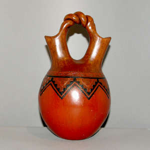 Band of Navajo carpet design on a brown wedding vase with a twisted handle
