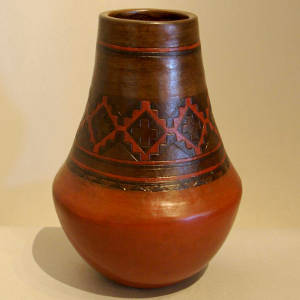 Navajo carpet design on a tall brown jar