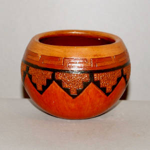 Navajo carpet design on a brown jar