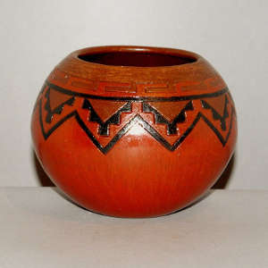 Navajo carpet design around the rim of a brown jar