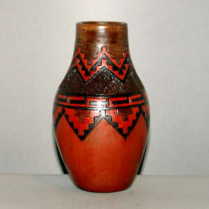 Navajo carpet design around the neck of a brown vase