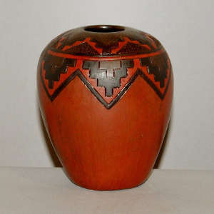 Navajo carpet design around the shoulder of a red jar