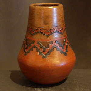 Navajo carpet design on a tall neck brown jar