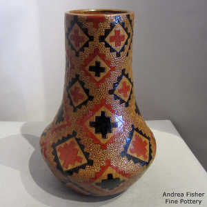 Pine pitch coated polychrome jar with a Navajo carpet design