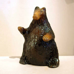 Pine pitch coats a small brown bear