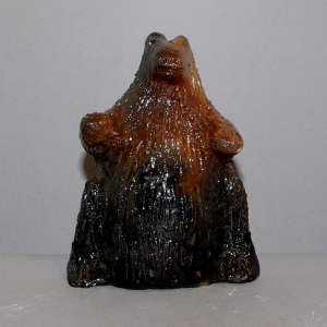Pine pitch coating on a small carved bear bank