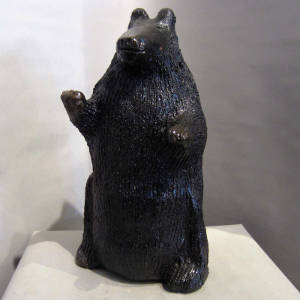 Pine pitch coating on a carved brown bear