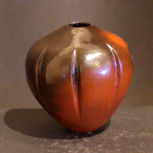 Fire clouds on a brown jar carved into a melon shape