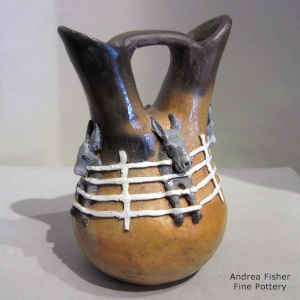 A band of fencing enclosing donkeys around a brown wedding vase with fire clouds