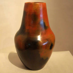 Fire clouds and pine pitch coating on a tall neck brown jar