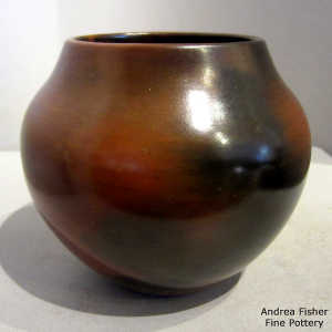 Pine pitch coating on a brown jar with black fire clouds