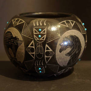 Sgraffito bear and bear paw designs with inlaid turquoise on a polished black bowl
