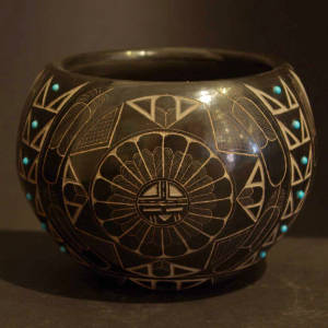 Sgraffito riders, buffalo, feathers and medallion signs plus inlaid turquoise on a burnished black bowl