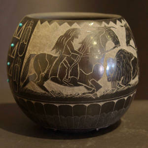 Sgraffito horseback riders and buffalo plus inlaid turquoise on a burnished black bowl