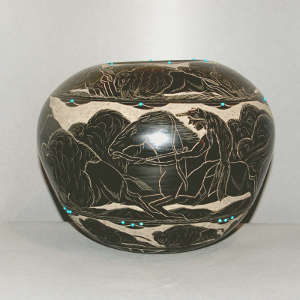 Sioux-heritage sgraffito design on a black jar with inlaid stones