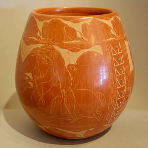 Sgraffito buffalo hunter and Sioux motif on a red jar