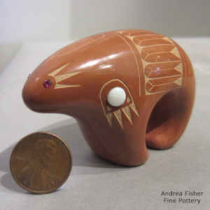 Miniature red bear figure decorated with a sgraffito feather, dancer and geometric design plus inlaid stones