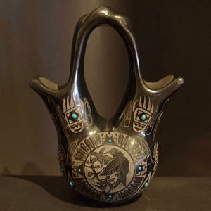 Sgraffito hummingbird, bear paw and feathers designs plus inlaid turquoise on a black wedding vase