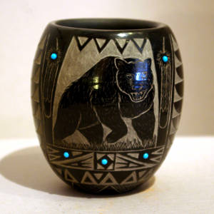 Sgraffito bear and Sioux geometric designs decorate a polished black bowl with inlaid turquoise