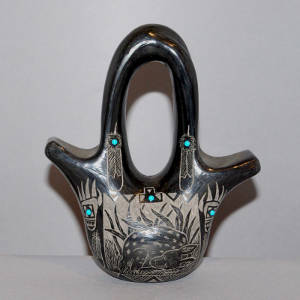 Sgraffito Sioux, deer and geometric design on a black wedding vase with inlaid stones