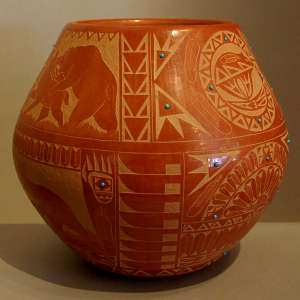 Sgraffito Sioux design plus inlaid stones on a red jar