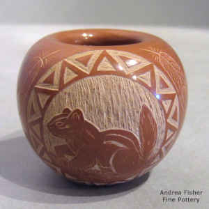 Miniature red jar decorated with a sgraffito squirrel, feather and geometric design