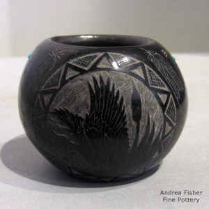 Miniature red jar with a sgraffito eagle, feather and Sioux geometric design plus inlaid stones