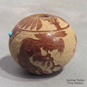 Miniature red jar with a sgraffito Sioux kokopelli, feather and Sioux geometric design plus inlaid stones