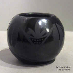 Deer track and geometric design on a black on black jar