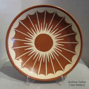 Cream on red plate with a geometric design