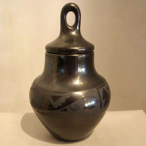 Geometric design on a lidded black on black jar