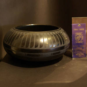 Feather and geometric design on a black on black jar