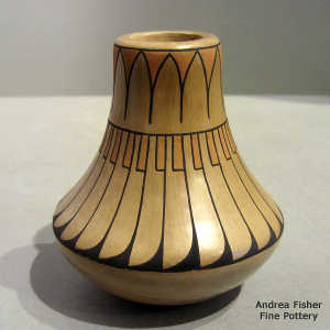 Feather and geometric design on a tall neck polychrome jar