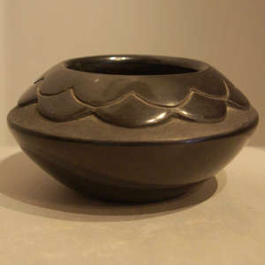 Cloud design carved into a black jar