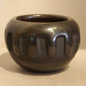 Rain design carved into a black jar